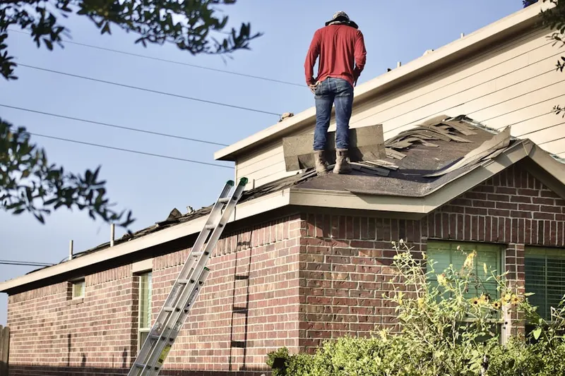 Professional roofer working on a residential roof in Bryn Mawr-Skyway